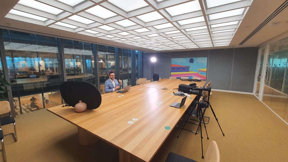 Tom in a premium boardroom filming a video for BuddyBoss