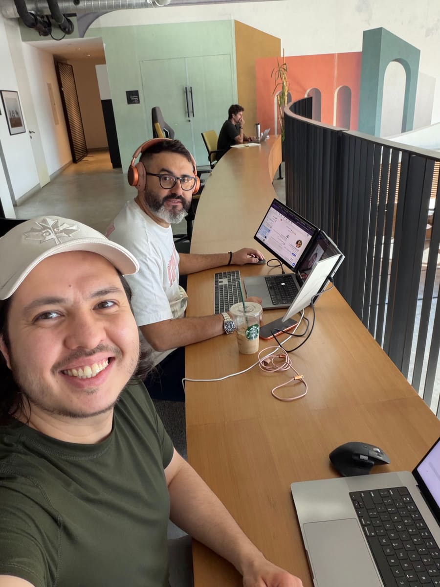 Tom and Jason Atakhanov working side by side at a co-working space